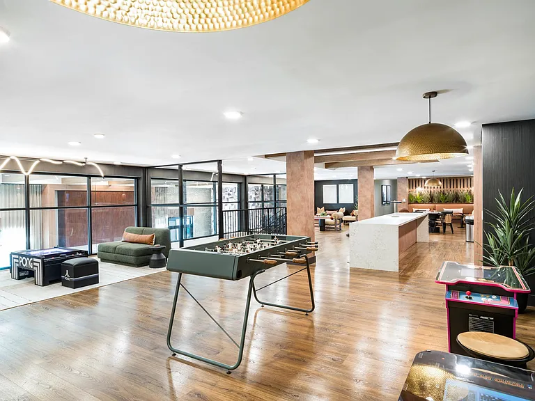 A dynamic resident retreat at Modera Higley Commons, featuring open gathering areas, curated games, and flexible spaces designed for connection.