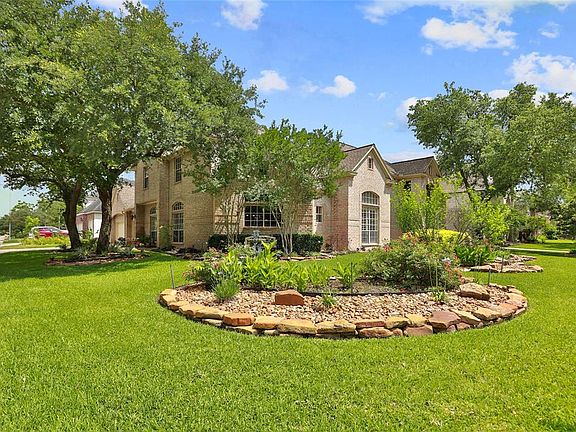 The house sits on a big corner lot with beautiful landscaping