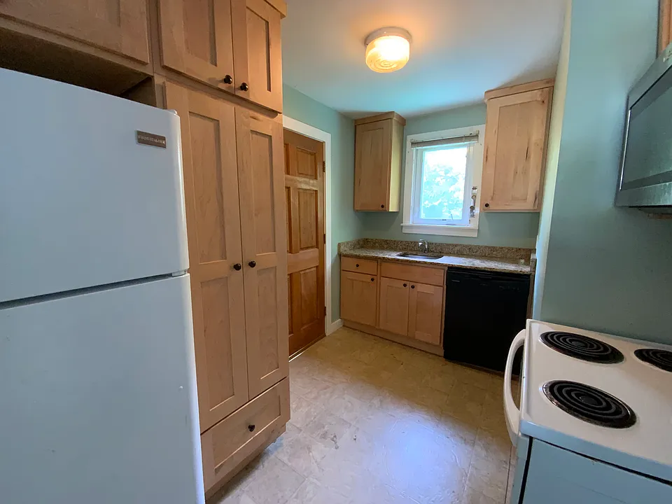 Solid maple kitchen with granite, microwave, and new dishwasher.