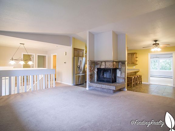 Living room with wood burning fireplace.