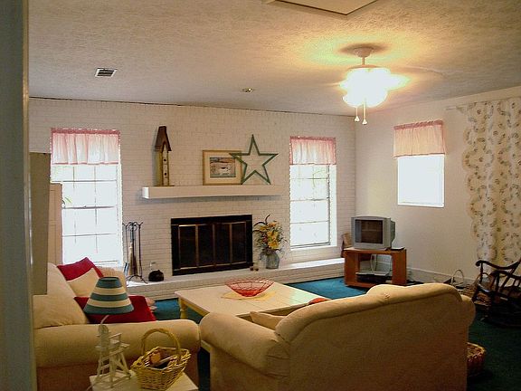 Huge family room with brick wall and fireplace