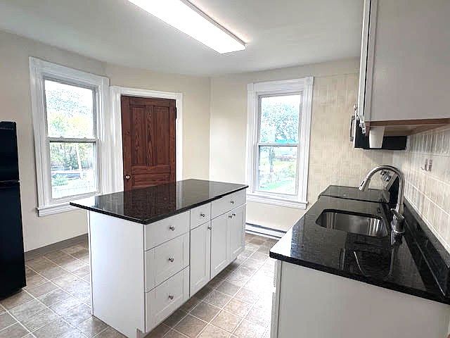 Center island w/ new granite countertops. Seats 3