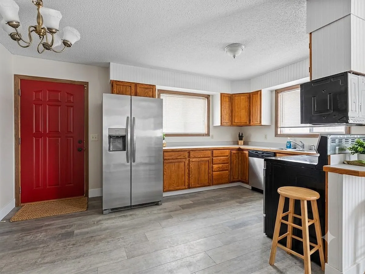 Well-appointed kitchen with stainless steel appliances, ample cabinet storage, generous counter space, and a functional layout.