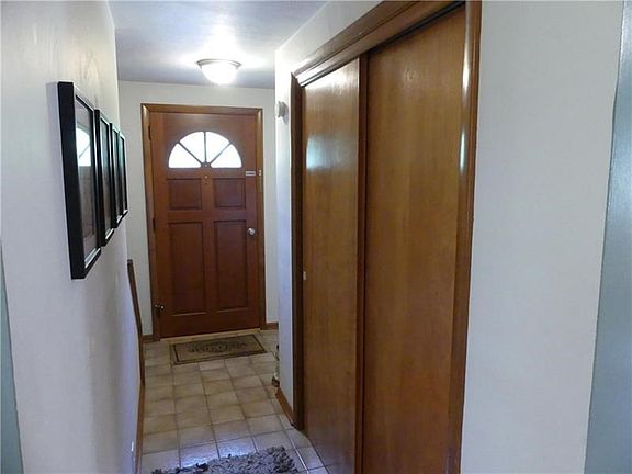 The entry has a generously sized coat closet, note the easy to clean tile floor.