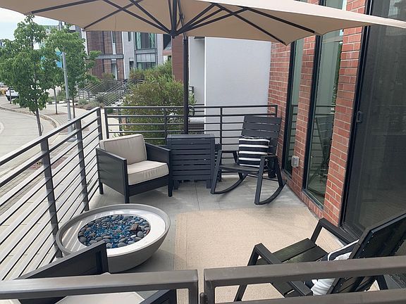 Park-facing patio with outdoor fireplace
