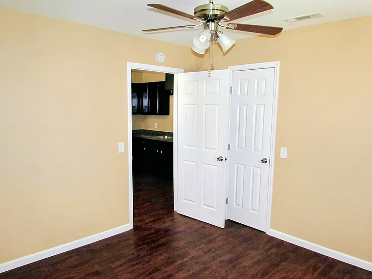 Large bedroom with ceiling fan.