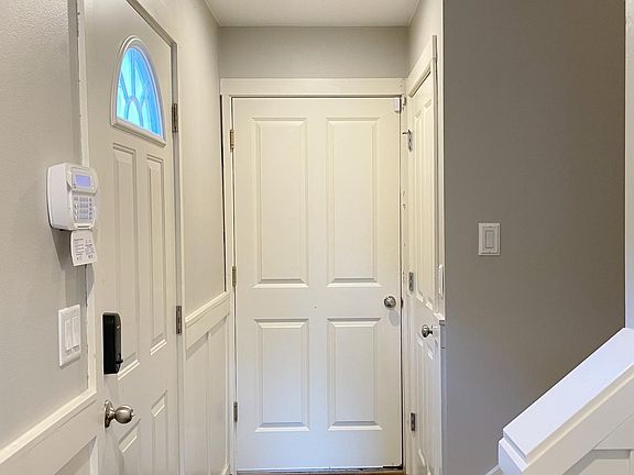 Hall way at the first floor with access to the garage