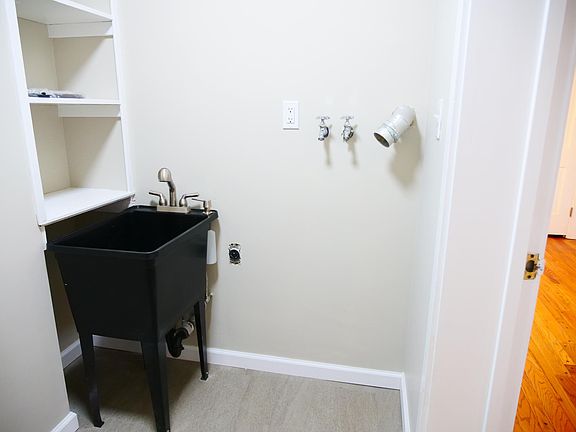 Laundry room with hook-ups, sink shelving and coat rack