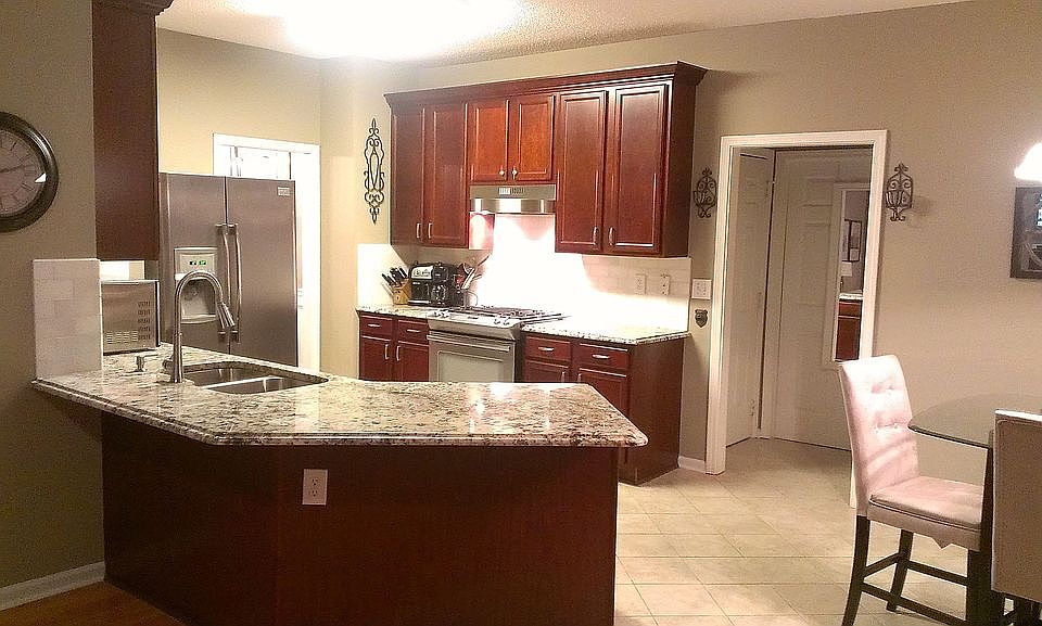 Beautifully renovated kitchen with granite countertops and marble backsplash