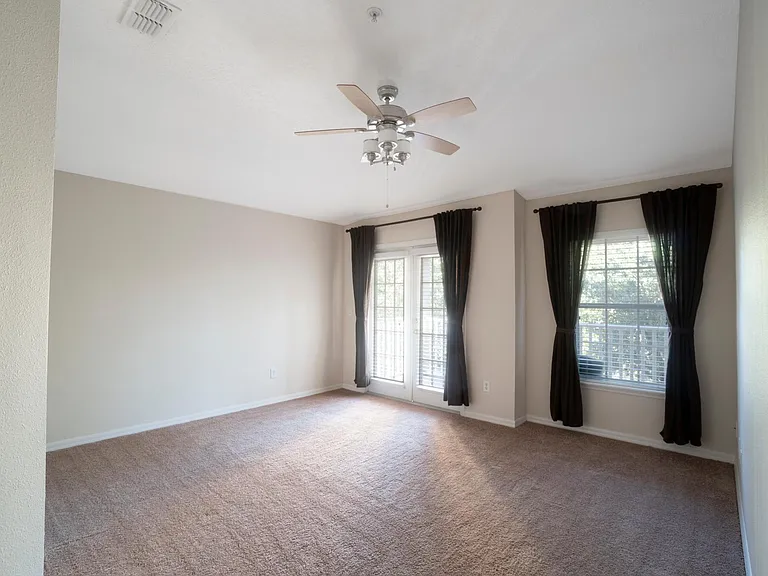Master bedroom with french door entrance to balcony
