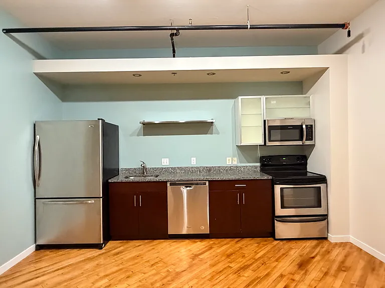 Kitchen (Photos of similar unit with same floor plan. Unit 211 will have higher exposed beam ceilings. Colors, finishes, and fixtures may vary)