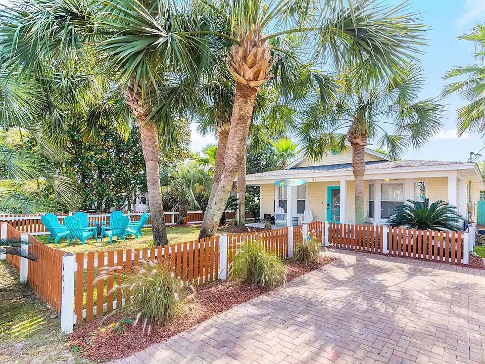 Welcome to Cabana Life Beach House! Palm trees, lovely beach house, picket fence, and a fire pit!