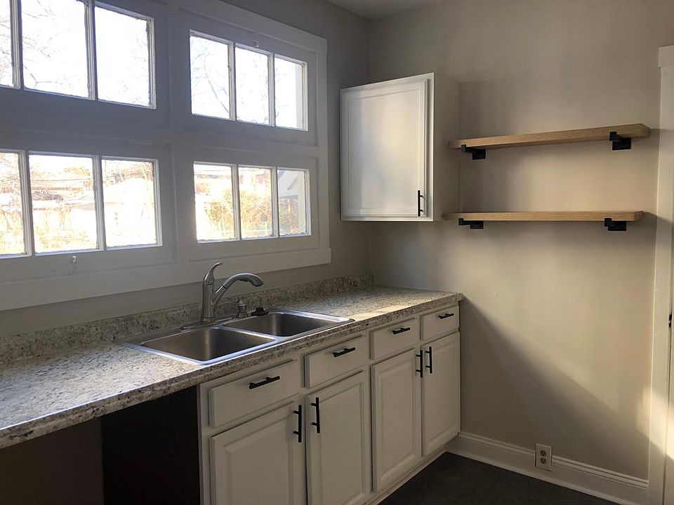 Kitchen with stainless steel appliances. Dishwasher, microwave, gas stove, sink disposal, side by side stainless steel refrigerator.