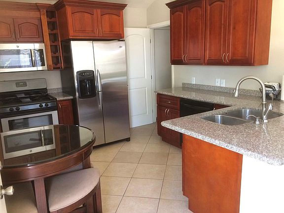 Practical kitchen with lots of counter space. Laundry room door at back.