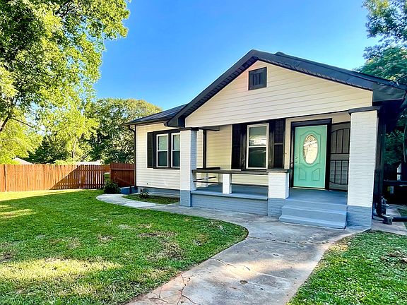 nice porch and fenced front yard