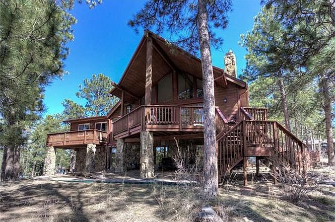 Front deck and living room upstairs, which look over the pines and at Bergen Peak, and the lower/ ground level. The master suite with it's own balcony is on the far left of house.