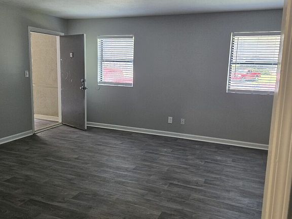 Spacious living room with vinyl flooring.