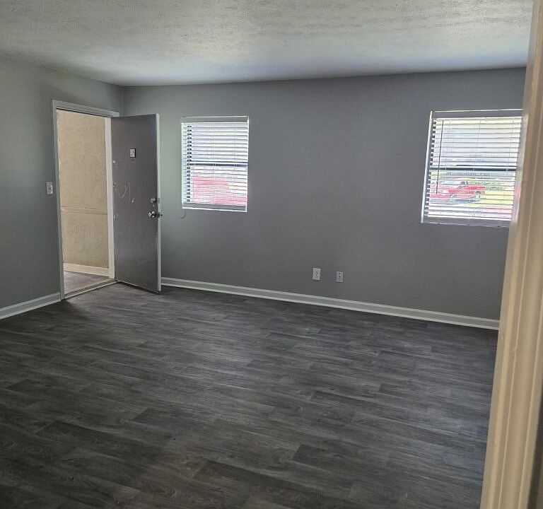 Spacious living room with vinyl flooring.