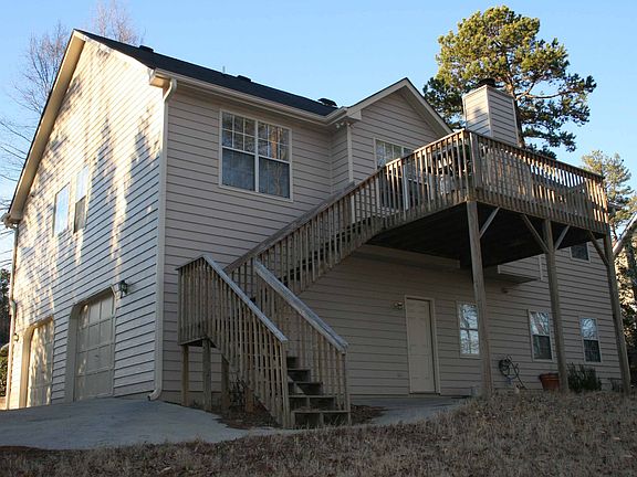Back of home with wooded view