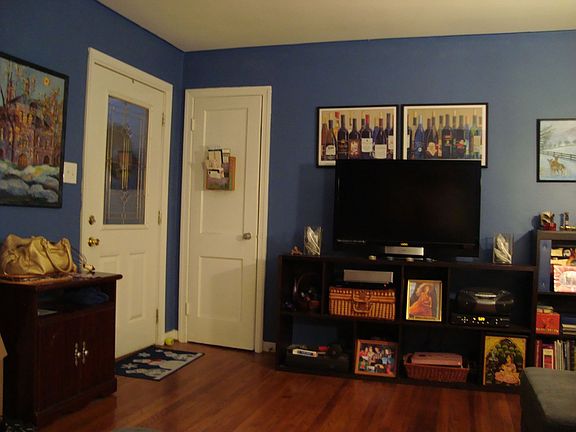 Front door and coat closet.  Original hardwood floors throughout