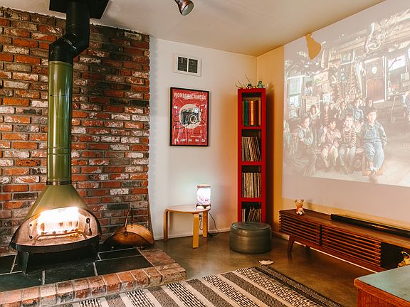 watch a movie on the wall by the fireplace.