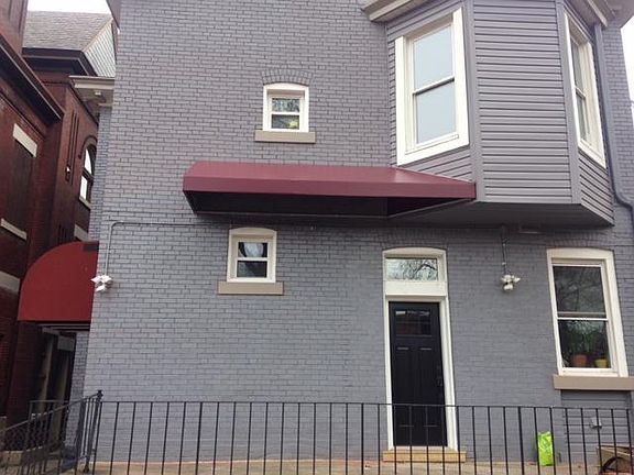 Entrance to back stairs and third floor apt is the covered awning on the left side of this photo.