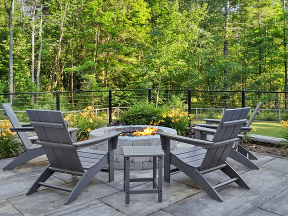Fire pit overlooking backyard and pool area