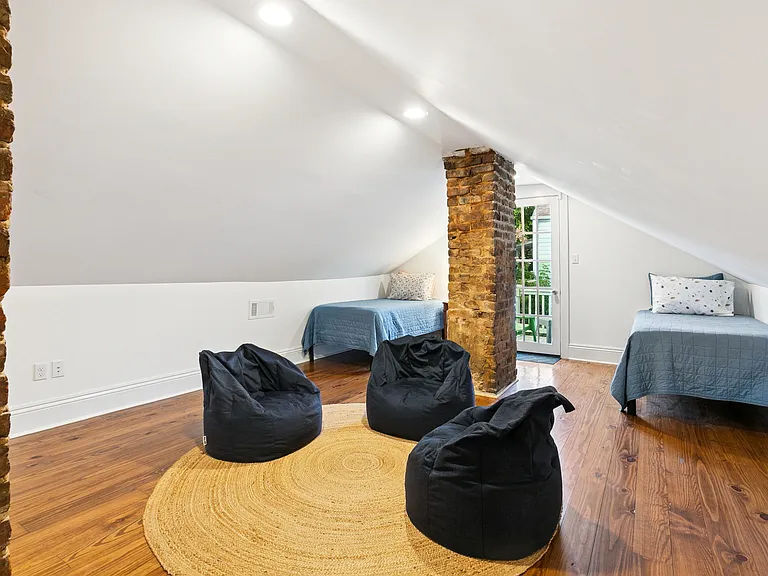 Guest room 3 (upstairs), 2 twin size beds, bean bag loungers, back door exits to peaceful outdoor balcony