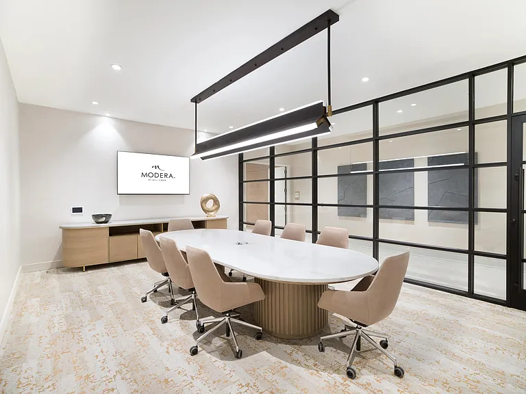 Our community features a modern conference room designed for focused meetings, collaborative work, and everyday productivity at Modera Liberty Row.