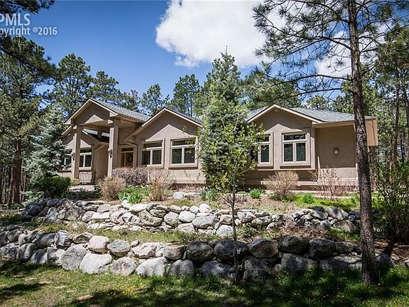 Custom ranch home with workshop, wine cellar and large walk-out basement.