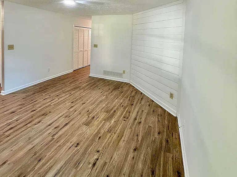 Subtle texture accent_ - white shiplap wall brings modern farmhouse style and warmth to the living room - adds visual interest without overwhelming the space