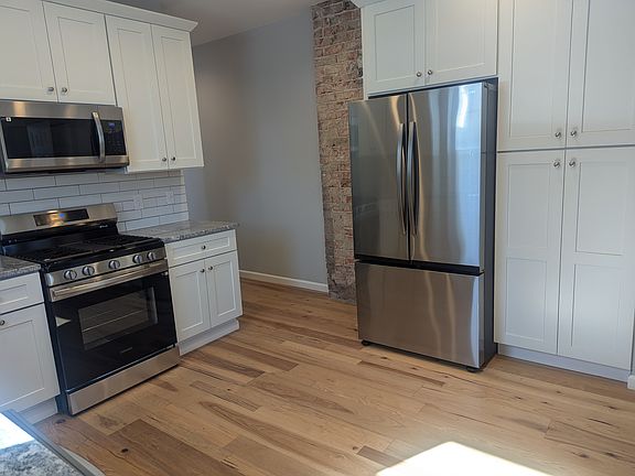 Kitchen with new refrigerator, gas stove, and dishwasher