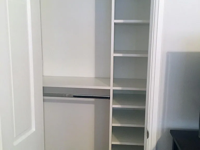 Primary bedroom second closet - shelves extend past the door frame.