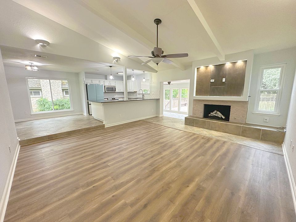 Enter the vaulted ceiling living room connected to an open-concept kitchen and dining space! ...Because slaving away in a kitchen hole like the help on Downton Abbey isn't as glamorous as they make it look on TV.