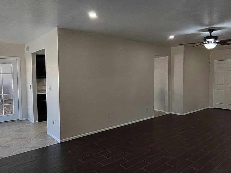 Living room with view to breakfast nook and view of entry way/front door