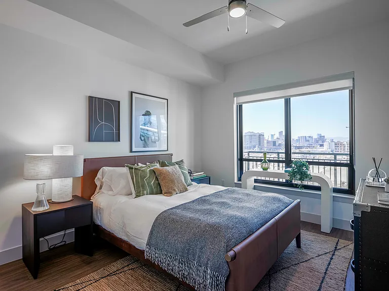 Serene space with warm accents and skyline views.