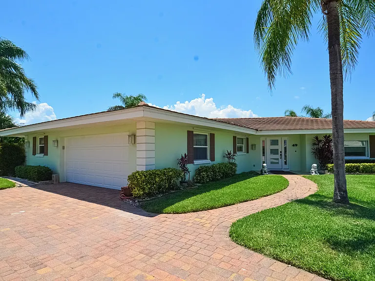 Front of house - two car garage, large driveway to accomodate two additional vehicles