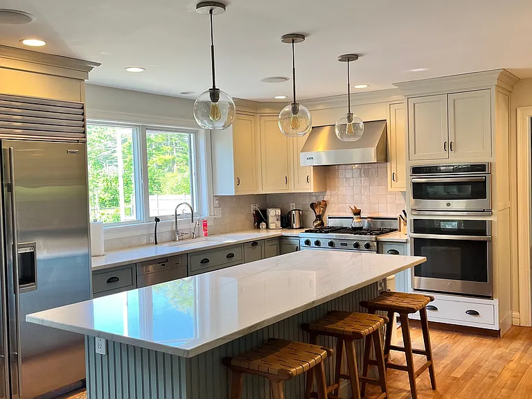 Kitchen with Sub Zero fridge, Miele dishwasher, Viking gas stove, and double wall ovens.