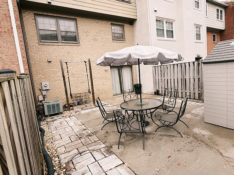 Hardscaped and full fence backyard. (patio furniture staging only)