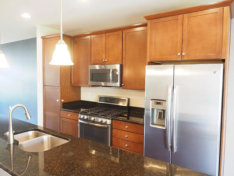 Large granite counters flank the double sink in the kitchen area.
