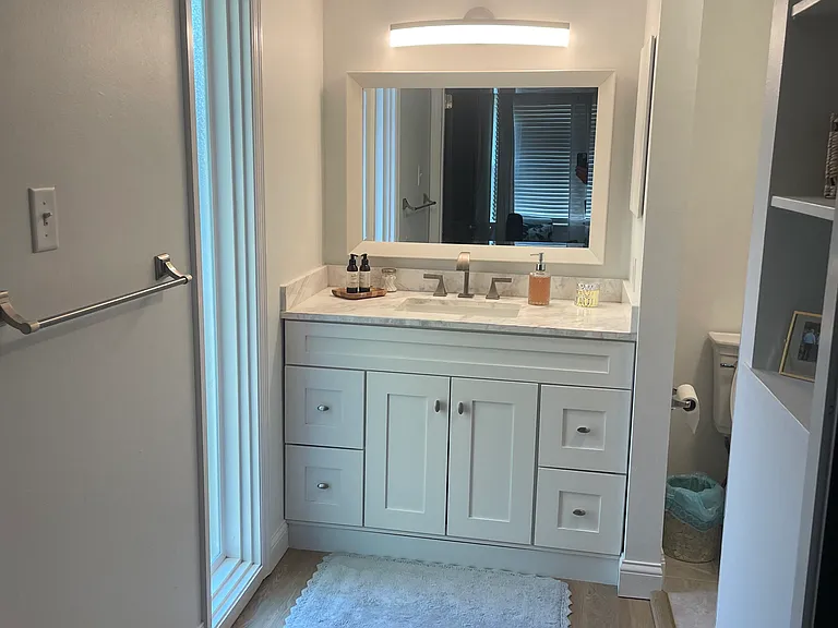 Primary Bedroom ensuite bathroom (New). Bedroom behind view and toilet & shower to the right