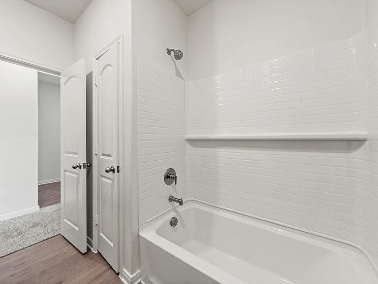 The secondary bathroom has a shower-tub combo.