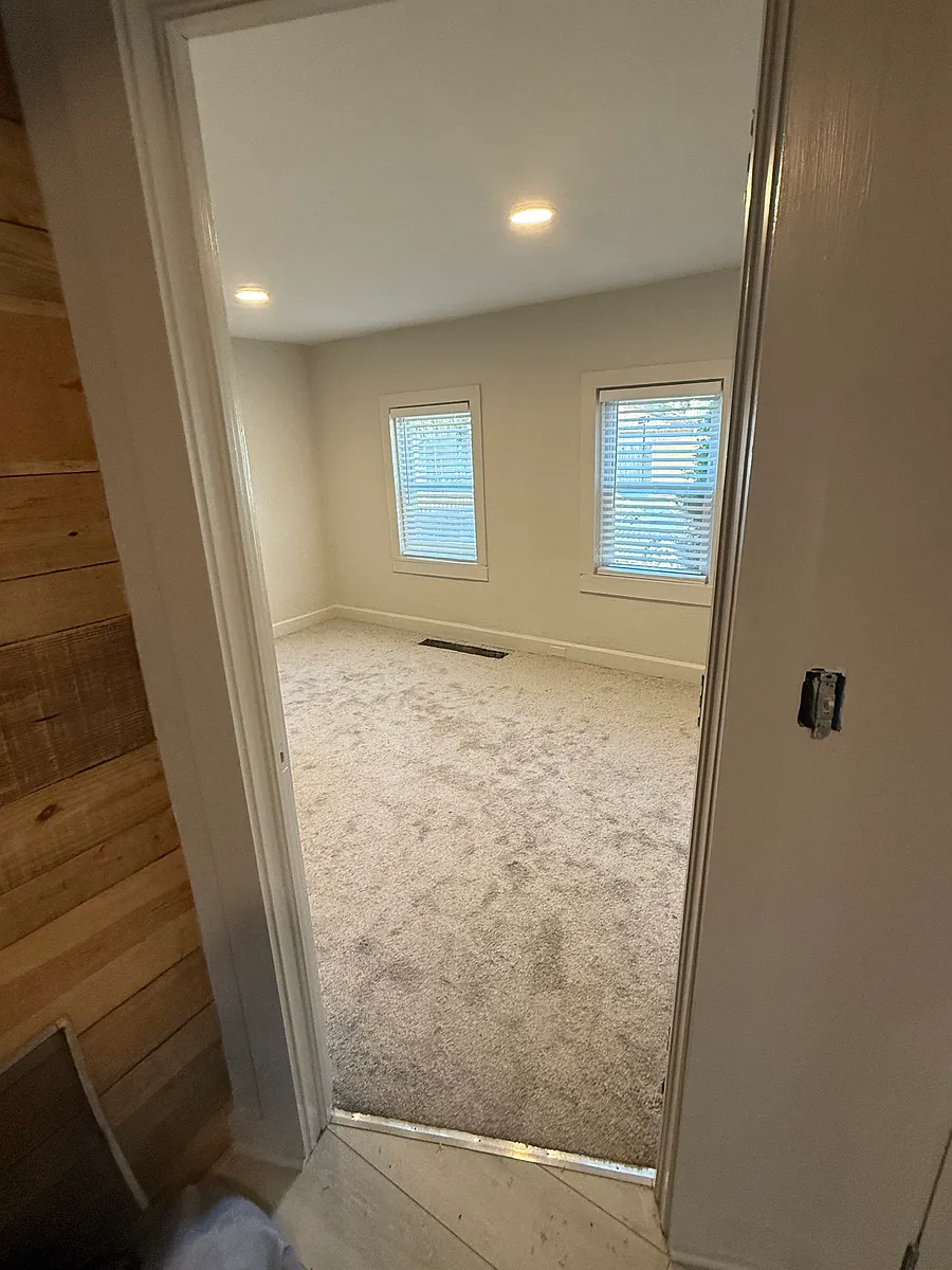 No section 8 Updated single family ranch located between a neighborhood garden and vacant lot It's a fenced in lot with a sliding entry gate to park inside property House has alley in rear of property where u enter gate Concrete counters — photo 3