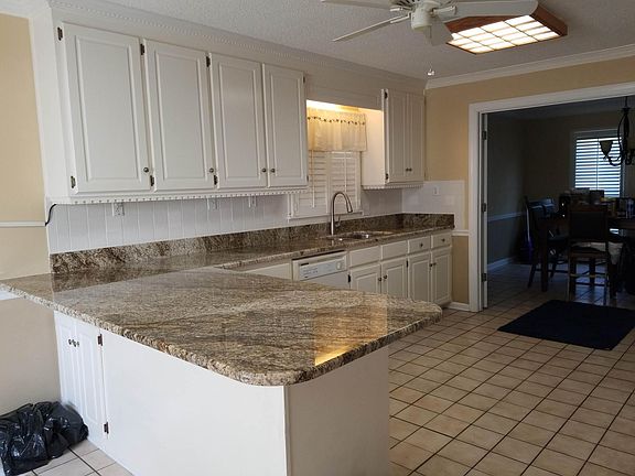 Large kitchen with LOTS of counter-top space. Stools can fit under the peninsula for you rmorning breakfast.