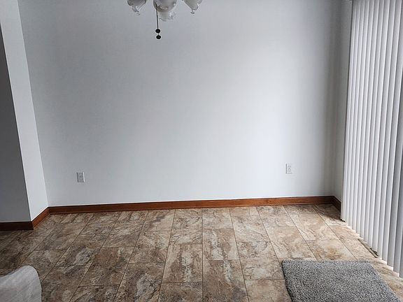 Dining Room with sliding glass door with verticals.