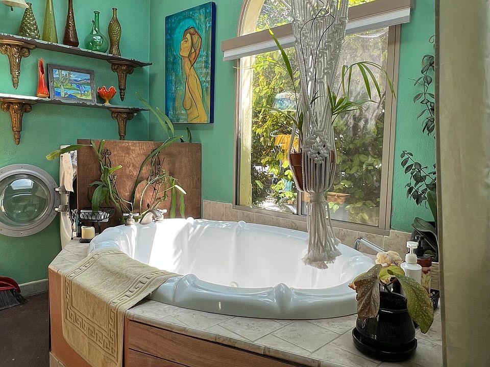 Soaking tub in bathroom under skylights