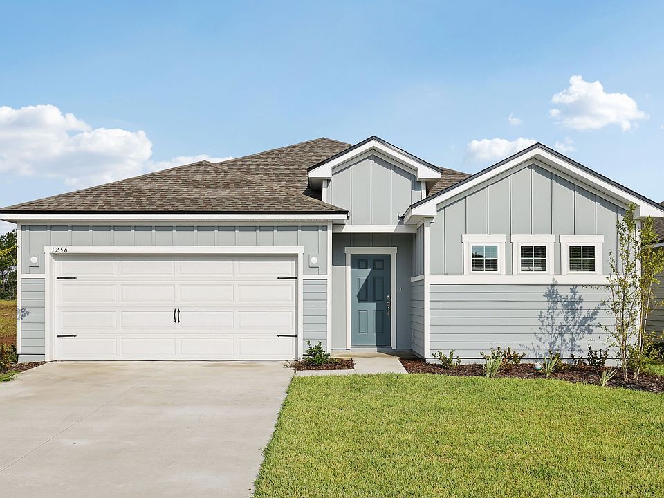 Elegant gable roof and chic grey facade define this stylish Panther Creek residence s modern allure.