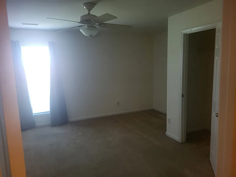 4th bedroom with fan, large closet, room darkening curtains