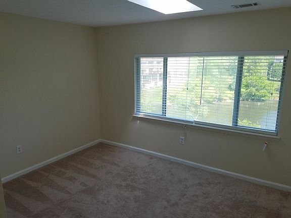 Master bedroom with large picture window overlooking pond
