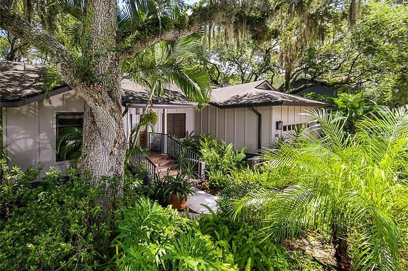 Tropical surroundings will welcome you to this light and bright home.